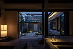 Minimalist residential interior with concrete, glass, and metal elements.