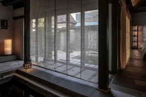 A minimalist residential interior featuring wooden elements.