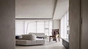 Modern living room with neutral tones and minimalist furniture.