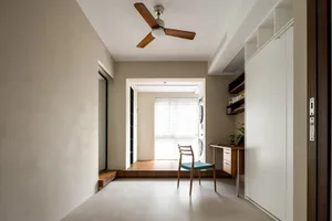 A minimalist residential space featuring a concrete floor and walls.