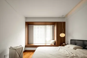 Modern minimalist bedroom featuring a wooden window, simple furniture, and neutral colors