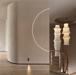 A modern interior design featuring a staircase illuminated by elegant, cylindrical pendant lights.