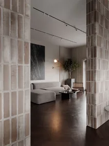 A modern living room featuring a concrete-tile floor and minimalist decor.