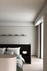 Modern minimalist bedroom with gray metallic and wooden accents.