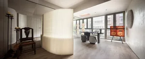 Contemporary minimalist living room with wood flooring, glass windows, and a paper wall divider