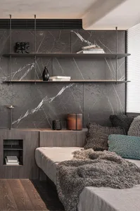Modern bedroom featuring a bed with a marble headboard and a marble accent wall.