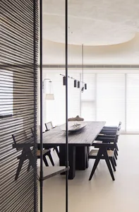 Modern dining room featuring wooden furniture and minimalist design.