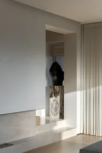 A modern minimalist interior design featuring marble elements.
