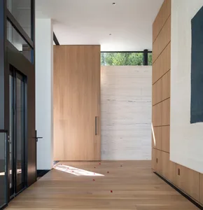 Entryway featuring wooden and marble materials with a minimalist design.