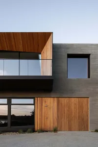 Modern house exterior with concrete and wood materials.