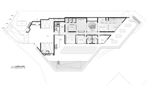 A technical drawing of a modern house's floor plan, showing various rooms and spaces.