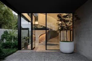 A modern industrial staircase with concrete steps and walls.