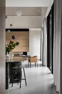 A modern living room featuring marble and glass elements.