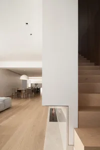 Modern living room with wooden floor and furniture, minimalist design.