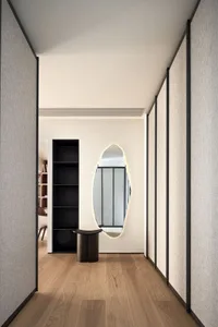 Modern hallway with textured wall panels and hardwood flooring