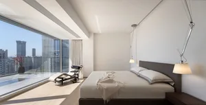 Modern interior design featuring glass windows and wooden flooring.