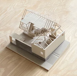 A detailed wooden model of a residential home, showcasing its structure and design.