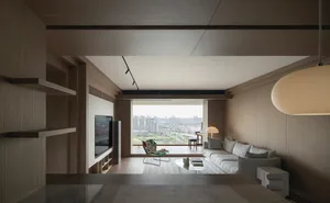 Modern living room with wooden furniture and a large window overlooking a cityscape.