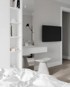 A minimalist bedroom with white walls, light wood floor, and a white bookshelf.