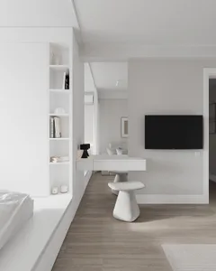 A modern minimalist bedroom with white furniture and wood flooring.