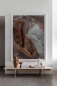 Modern, minimalist interior design featuring concrete surfaces and abstract art