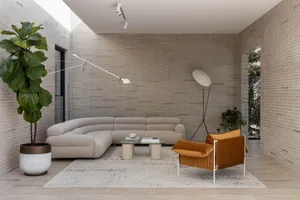 Minimalist living room with a modern sofa, coffee table, and floor lamp.