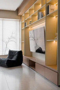 A minimalist living room featuring wooden furniture, glass shelves, and black upholstered seating.