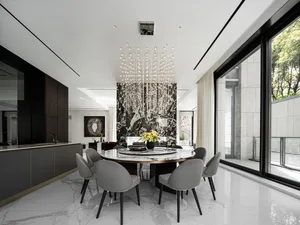 A modern dining room with marble furniture and a chandelier hanging above the table.