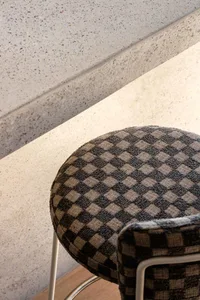 A modern chair with a checkered fabric upholstery, featuring a checked pattern.