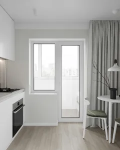 Modern minimalist kitchen with white cabinets, white countertops, white flooring, large window, and white furniture.