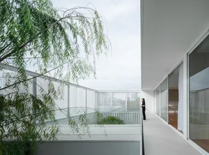 Modern high-rise living room with large window frame and white tile flooring
