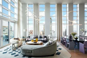 Modern living room with contemporary furniture, large windows, and city view.