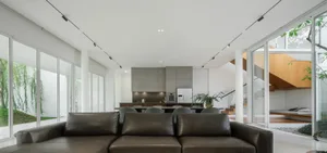 Contemporary living room featuring sleek, minimalist design with large glass windows