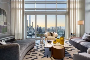 A modern living room with a panoramic city view through large windows, featuring a mix of materials and contemporary furnitur
