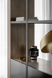 A modern bookshelf with metal and wood shelving and cabinets.