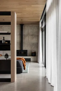 A modern living room featuring concrete floors and minimalist furniture.