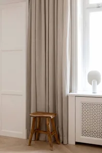 A minimalist bedroom featuring neutral-toned hues and a simple, understated decor.