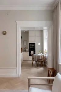 A minimalist residential kitchen featuring light wood finishes.