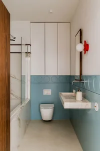 Modern bathroom featuring marble tiles and fixtures, with a sleek, contemporary design.