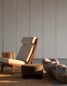 Modern lounge chair with cushions and footstool.