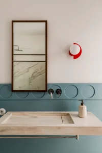 Modern bathroom with marble sink and minimalist design elements.