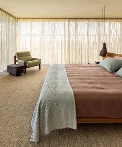 A minimalist bedroom with a wooden platform bed and light-colored bedding.