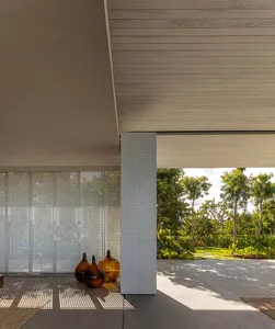 Modern, minimalist house exterior featuring concrete and perforated metal