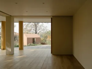 A modern residential interior showcasing wood flooring and natural light.