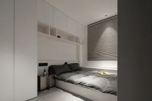 A minimalist bedroom featuring neutral-toned textiles on a built-in bed with integrated storage and a simple headboard