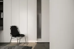 A modern interior design featuring a black leather chair.