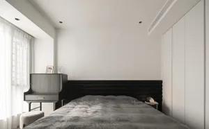 Minimalist bedroom with black furniture and wooden headboard
