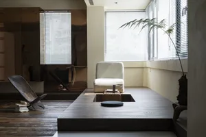 A minimalist residential interior featuring wood and glass materials.