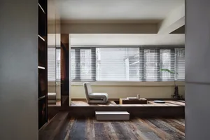 A modern living room featuring wood, steel, and blinds.