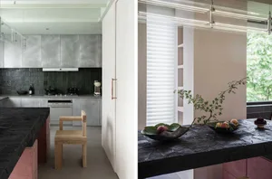 A minimalist kitchen with metallic cabinets and wooden seating.